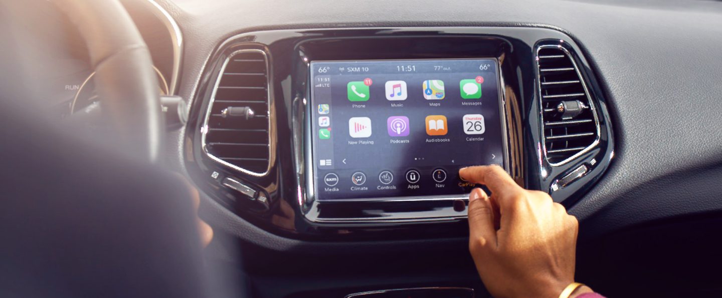 A close-up of the Uconnect touchscreen in the 2021 Jeep Compass, displaying the Apple CarPlay selections.