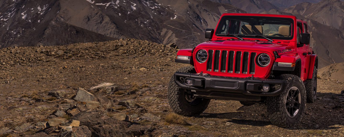A 2019 Jeep Wrangler Rubicon parked on a rocky trail.